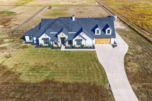 a aerial view of a house with swimming pool