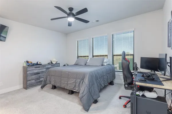 a bedroom with a bed and a desk