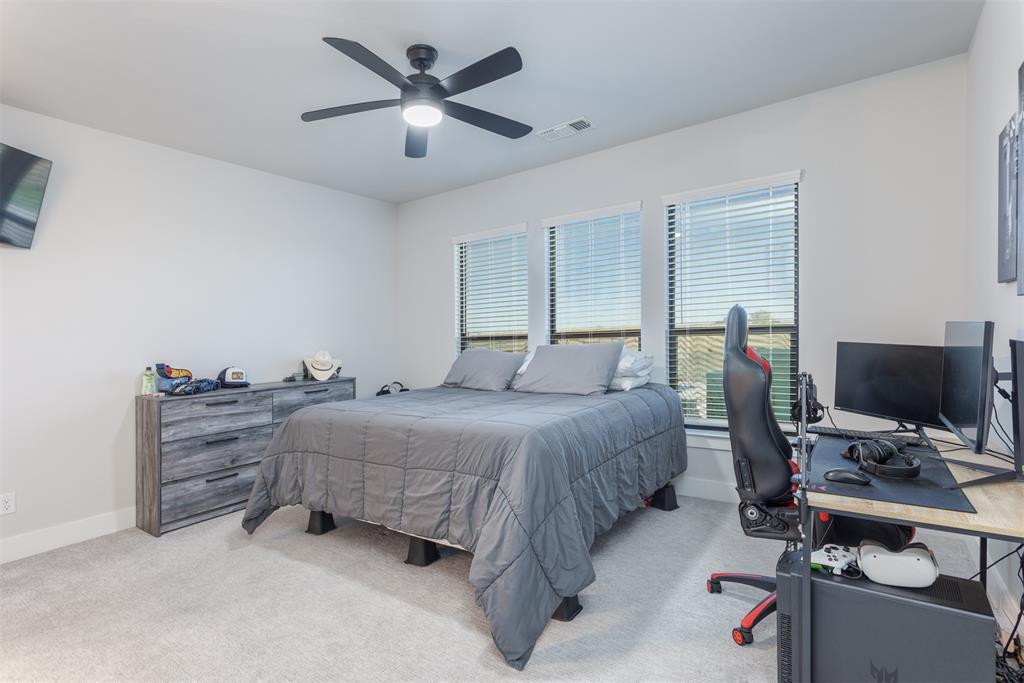 1810 Jc Maples Road Gunter, TX 75058 - Photo 8 of 27 a bedroom with a bed and a desk