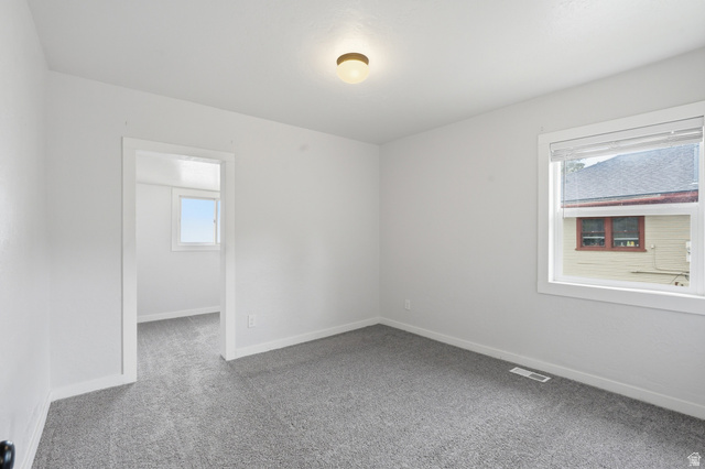 215 East 300 South Logan, UT 84321 - Photo 10 of 32 Carpeted empty room with baseboards