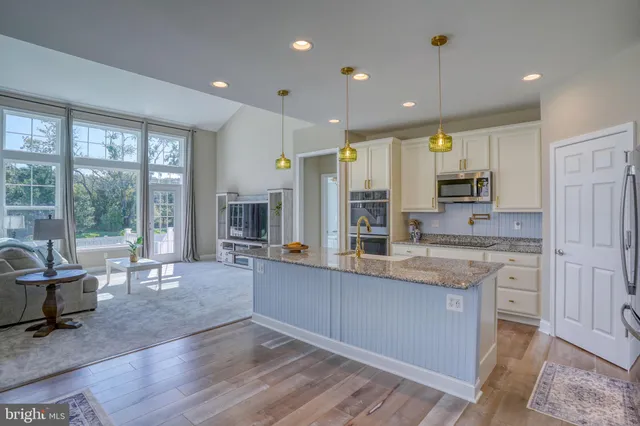 a living room with furniture and large windows