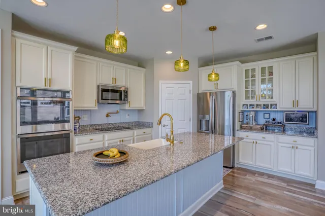 a bedroom with bed and a chandelier fan
