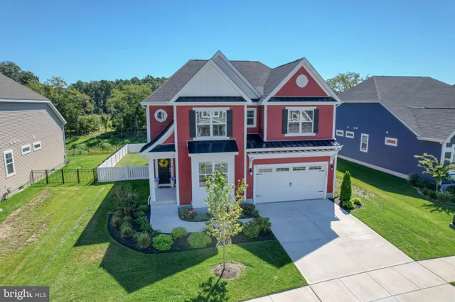 an aerial view of a house with a garden and swimming pool