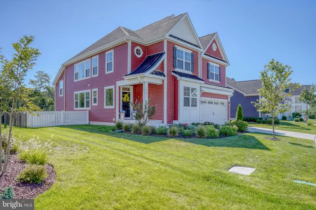 a view of a hallway with wooden floor and a livingroom