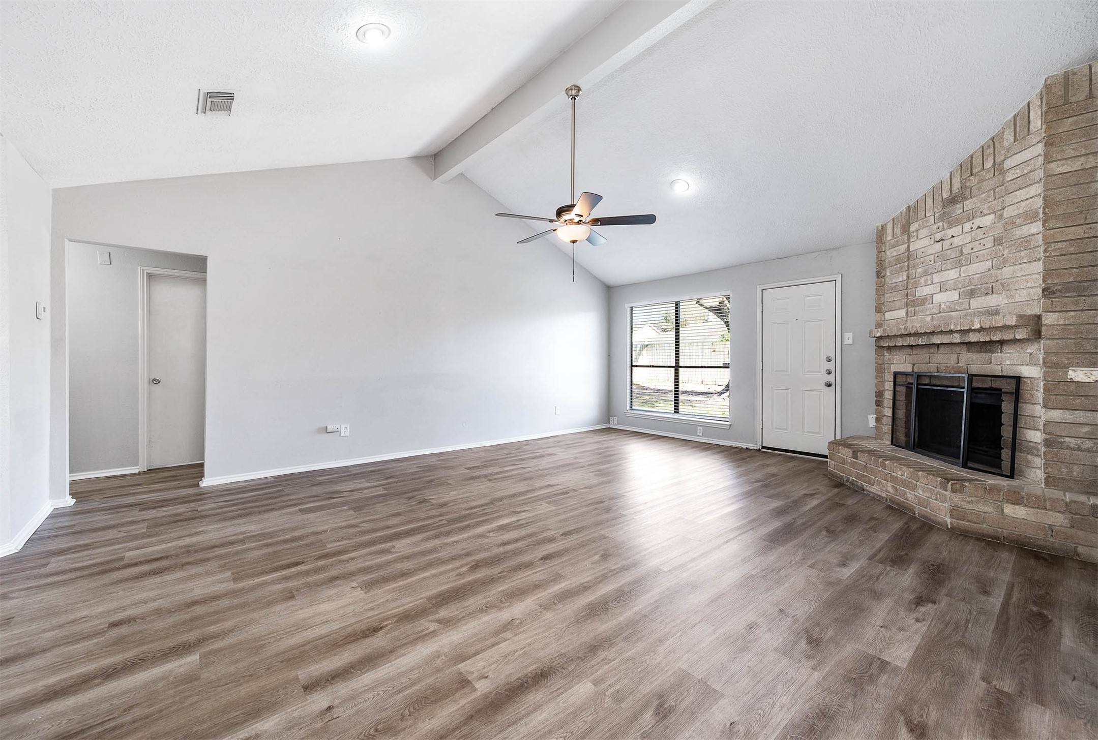 21402 Golden Dove Drive Spring, TX 77388 - Photo 11 of 29 an empty room with windows and a fireplace
