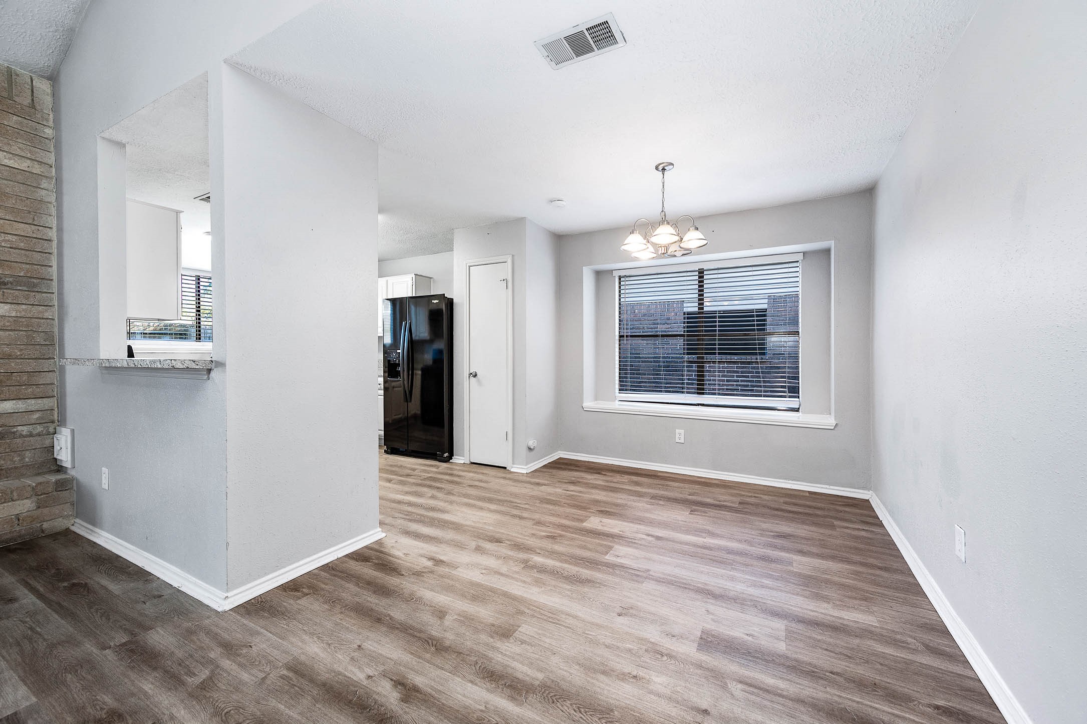 21402 Golden Dove Drive Spring, TX 77388 - Photo 12 of 29 an empty room with chandelier and windows