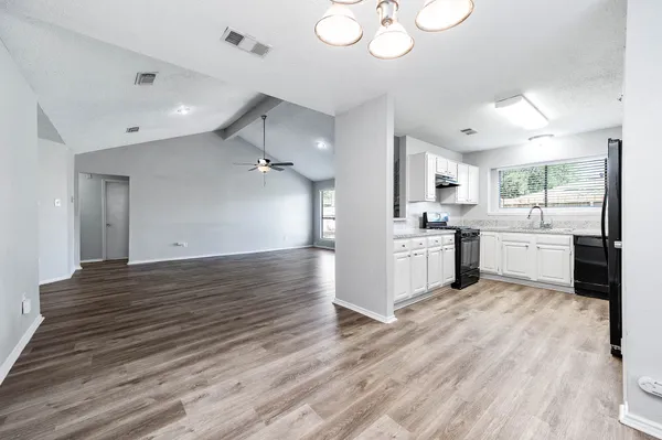 a view of a kitchen with a sink cabinets and wooden floor