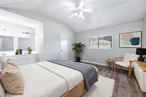 a bedroom with a bed and wooden floor