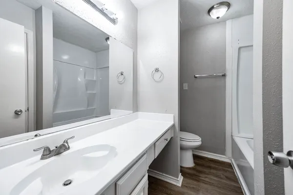 a bathroom with a sink toilet and shower