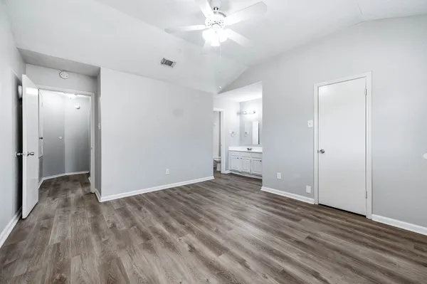 a view of an empty room with wooden floor