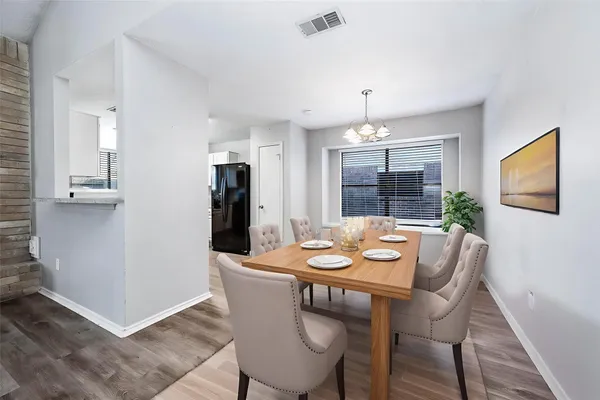 a view of a dining room with furniture window and wooden floor