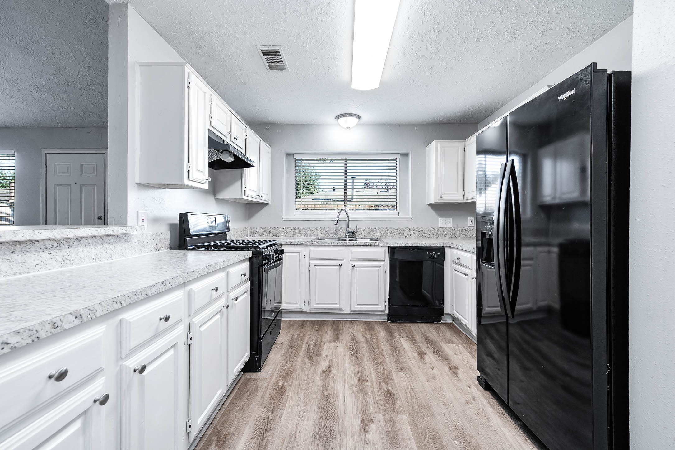 21402 Golden Dove Drive Spring, TX 77388 - Photo 4 of 29 a kitchen with white cabinets sink and stainless steel appliances