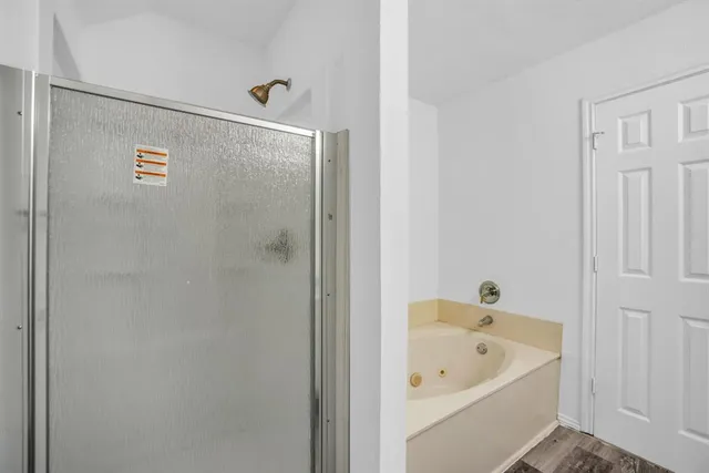 a view of a big room with wooden floor and a ceiling fan