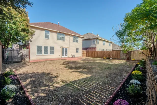 a backyard of a house with table and chairs