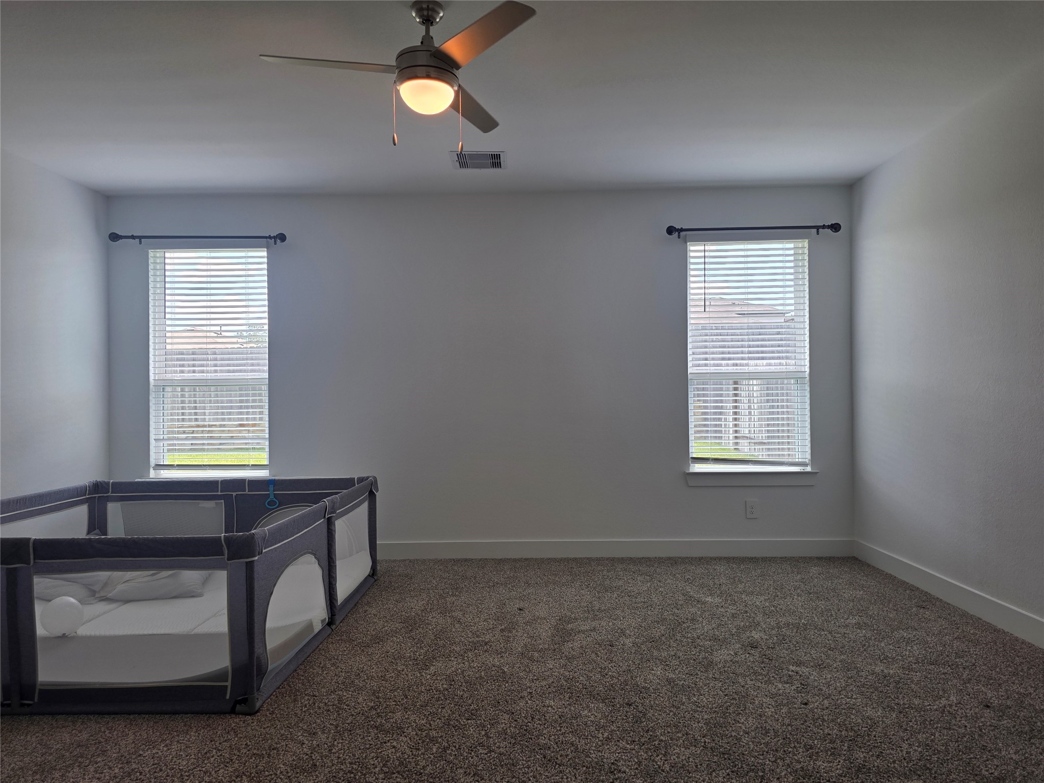 13725 Rising Sun Lane Conroe, TX 77384 - Photo 11 of 29 an empty room with windows and fan