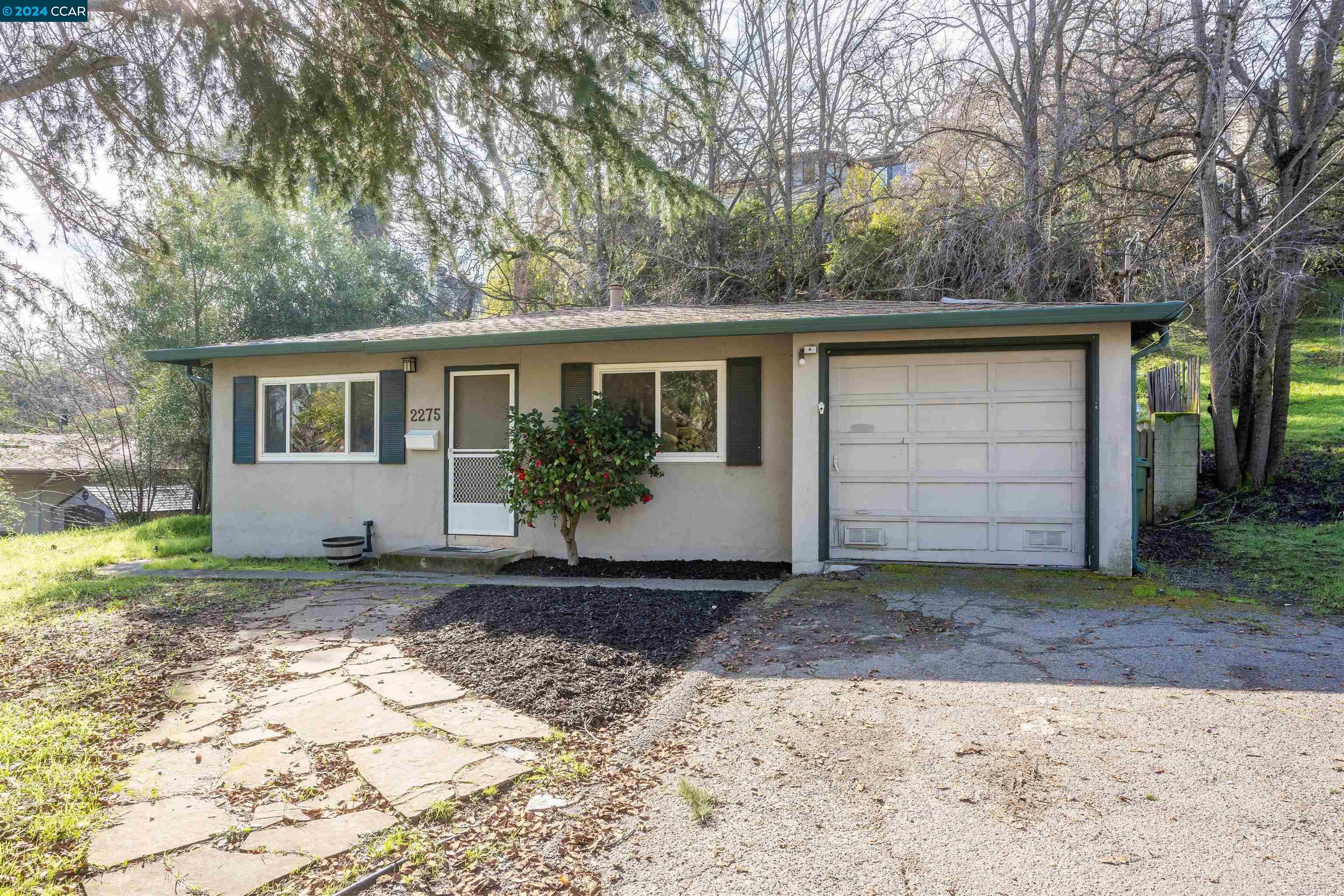 a front view of a house with garden