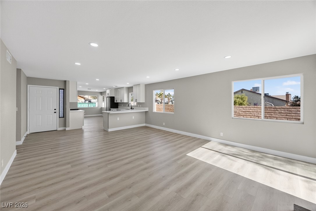 7071 Wedgewood Way Las Vegas, NV 89147 - Photo 16 of 37 Unfurnished living room featuring recessed lighting and light wood-style flooring