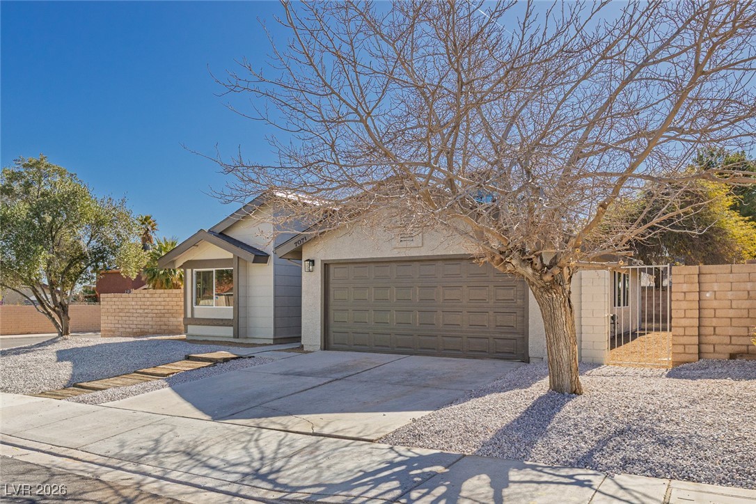 7071 Wedgewood Way Las Vegas, NV 89147 - Photo 2 of 37 View of front facade featuring driveway, an attached garage, a gate, and stucco siding