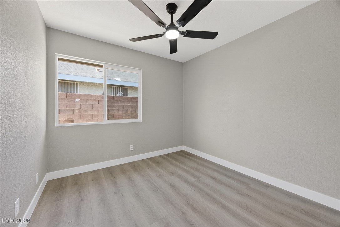 7071 Wedgewood Way Las Vegas, NV 89147 - Photo 24 of 37 Unfurnished room featuring light wood-type flooring, ceiling fan, and a textured wall