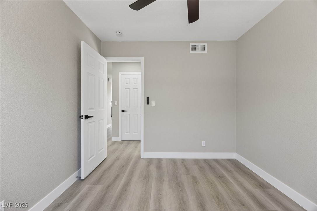 7071 Wedgewood Way Las Vegas, NV 89147 - Photo 28 of 37 Empty room with light wood-style flooring and a ceiling fan