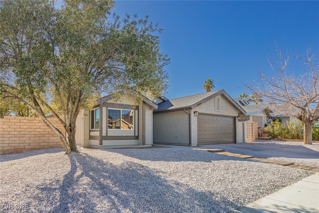 7071 Wedgewood Way Las Vegas, NV 89147 - Photo 3 of 37 Ranch-style house with concrete driveway, stucco siding, and a garage