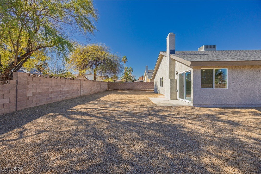 7071 Wedgewood Way Las Vegas, NV 89147 - Photo 32 of 37 Fenced backyard with a patio