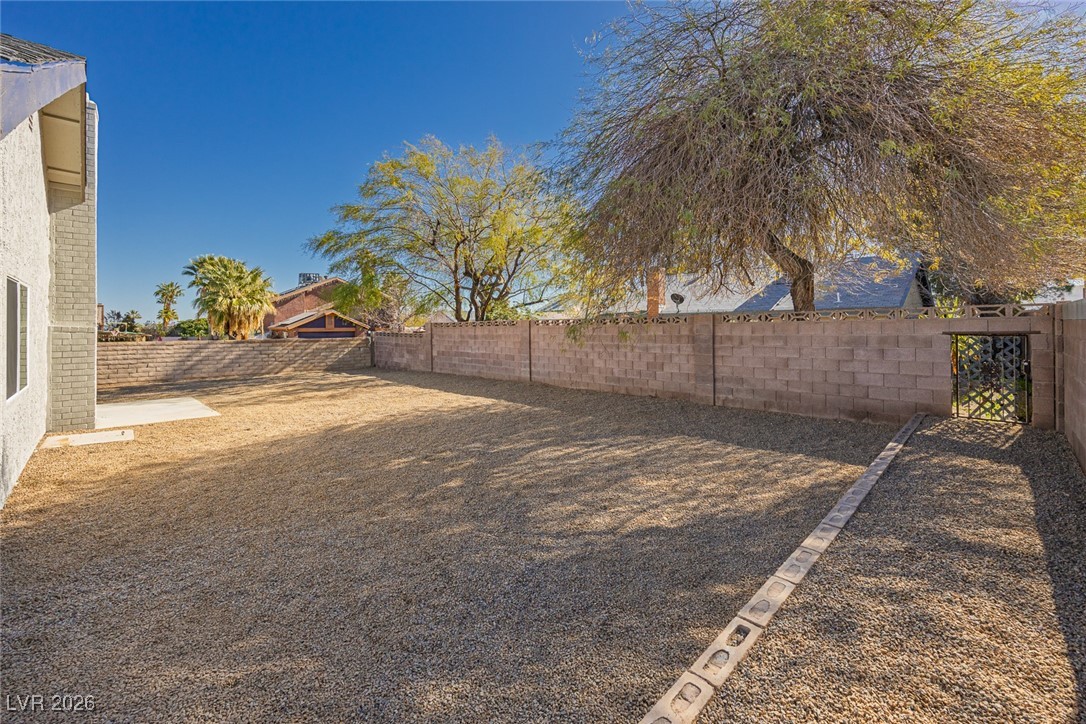 7071 Wedgewood Way Las Vegas, NV 89147 - Photo 36 of 37 Fenced backyard with a patio area