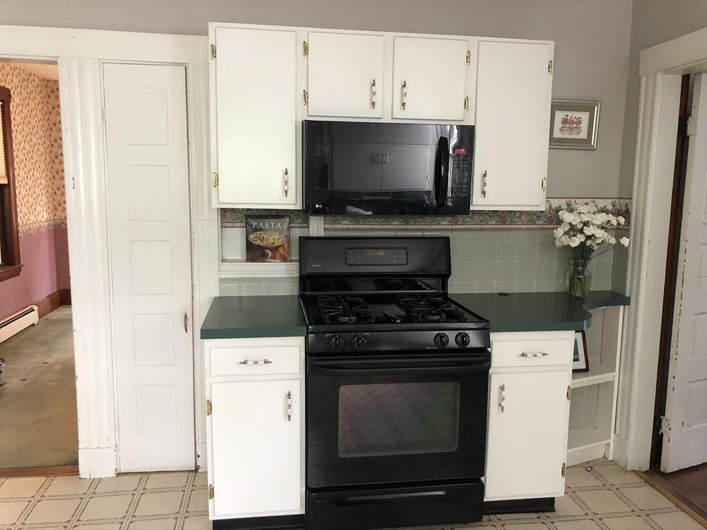 35 Adams Street Norwood, MA 02062 - Photo 11 of 40 a kitchen with a stove and a microwave