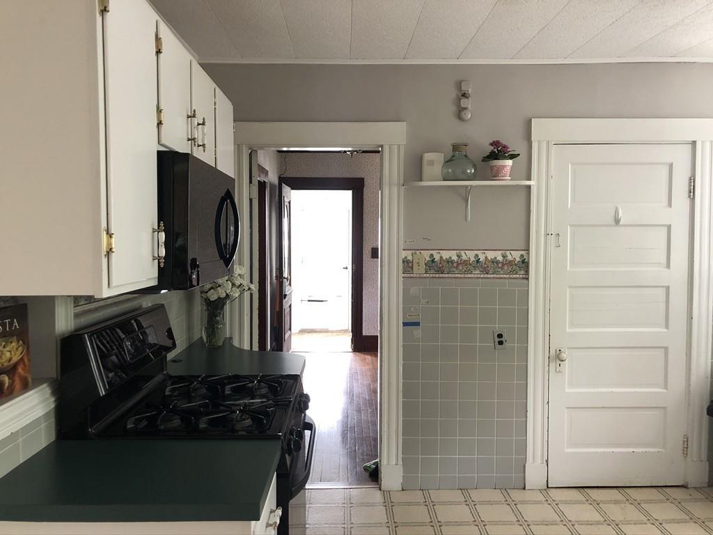 35 Adams Street Norwood, MA 02062 - Photo 13 of 40 a kitchen with stainless steel appliances a refrigerator and cabinets