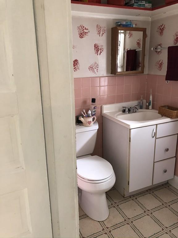 35 Adams Street Norwood, MA 02062 - Photo 16 of 40 a bathroom with a toilet sink and mirror