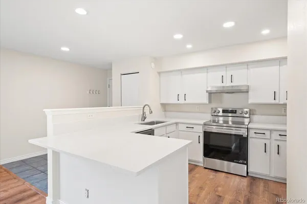 a kitchen with stainless steel appliances a sink stove and cabinets