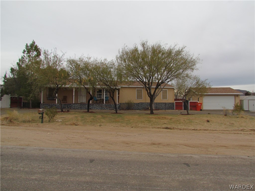 3500 Aztec Road Golden Valley, AZ 86413 - Photo 1 of 23 a backyard of a house with table and sofas