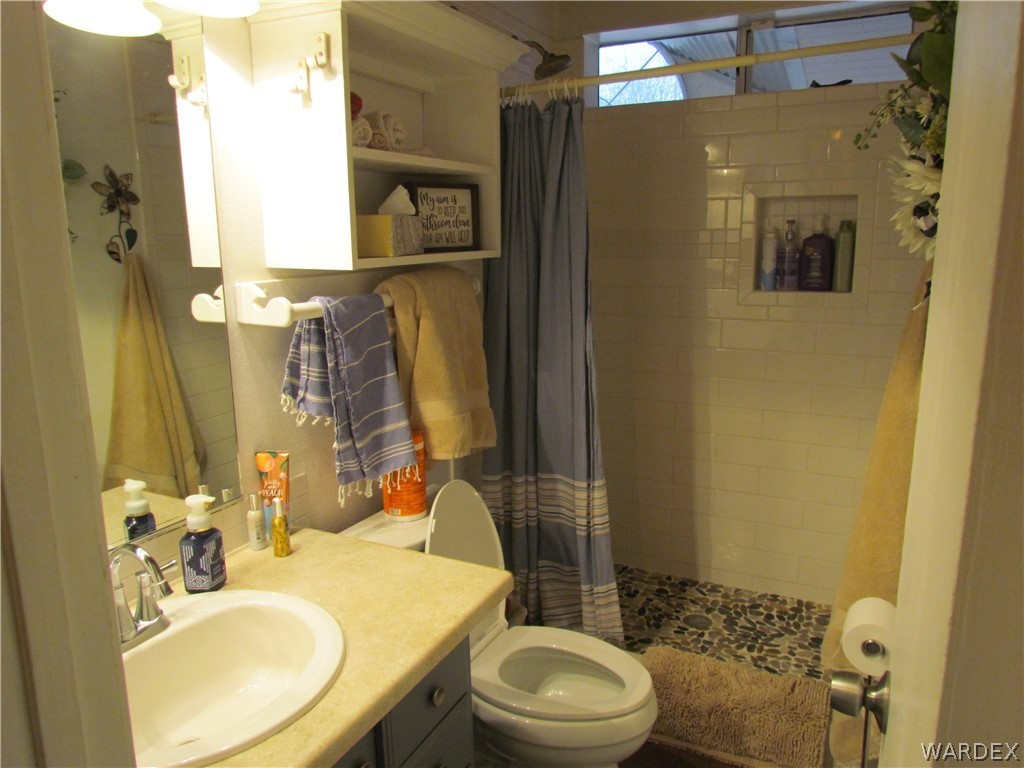 3500 Aztec Road Golden Valley, AZ 86413 - Photo 11 of 23 a bathroom with a sink toilet and shower