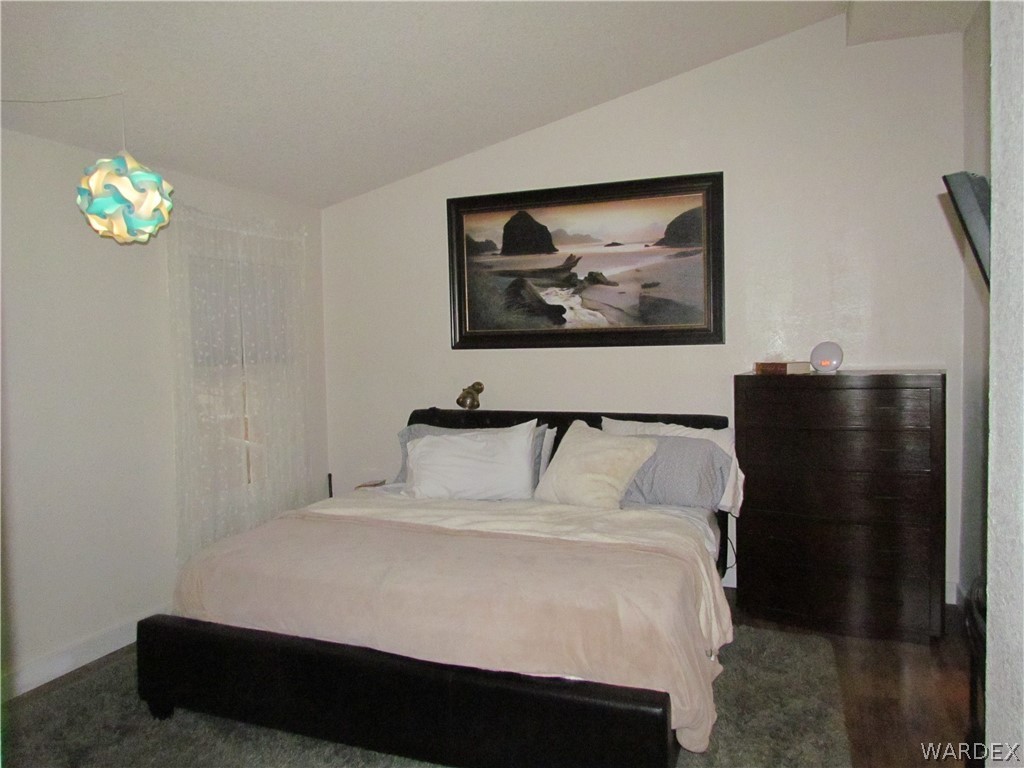 3500 Aztec Road Golden Valley, AZ 86413 - Photo 12 of 23 a bedroom with a bed and a painting on the wall