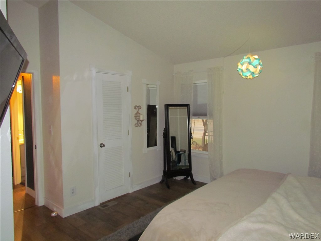 3500 Aztec Road Golden Valley, AZ 86413 - Photo 13 of 23 a bedroom with a bed and a chandelier