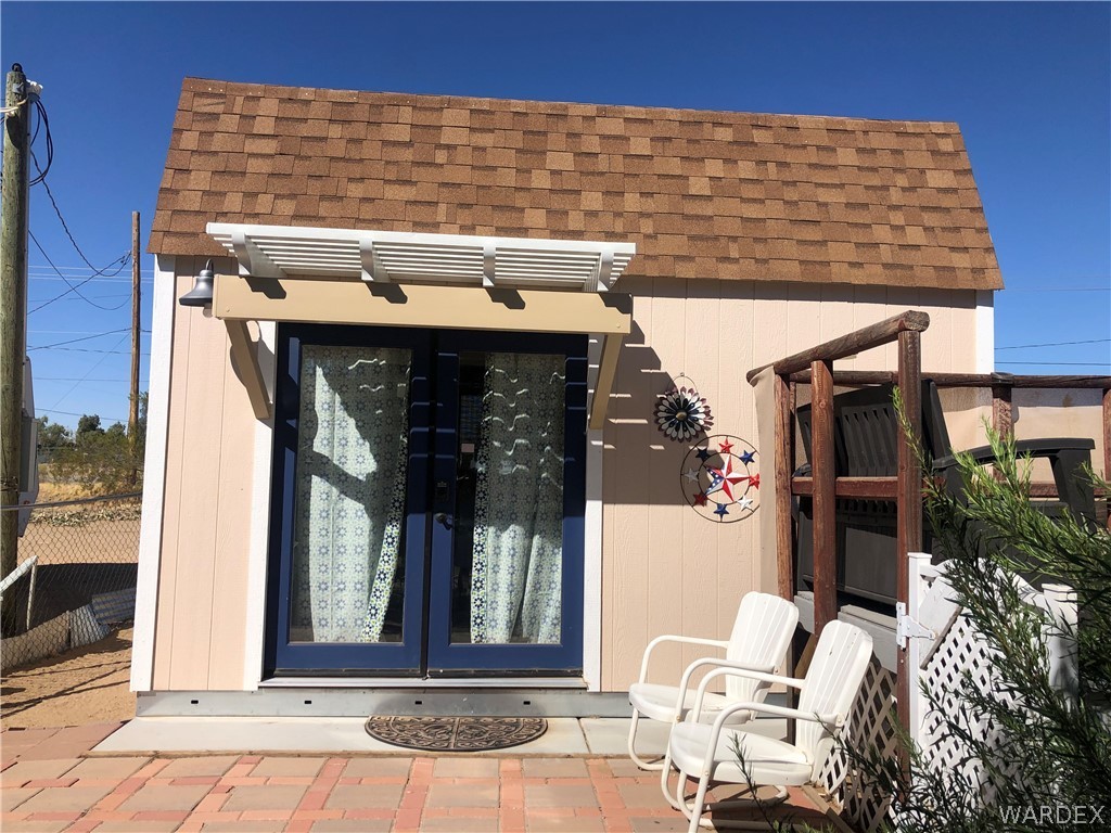 3500 Aztec Road Golden Valley, AZ 86413 - Photo 19 of 23 a view of a brick house with outdoor seating space