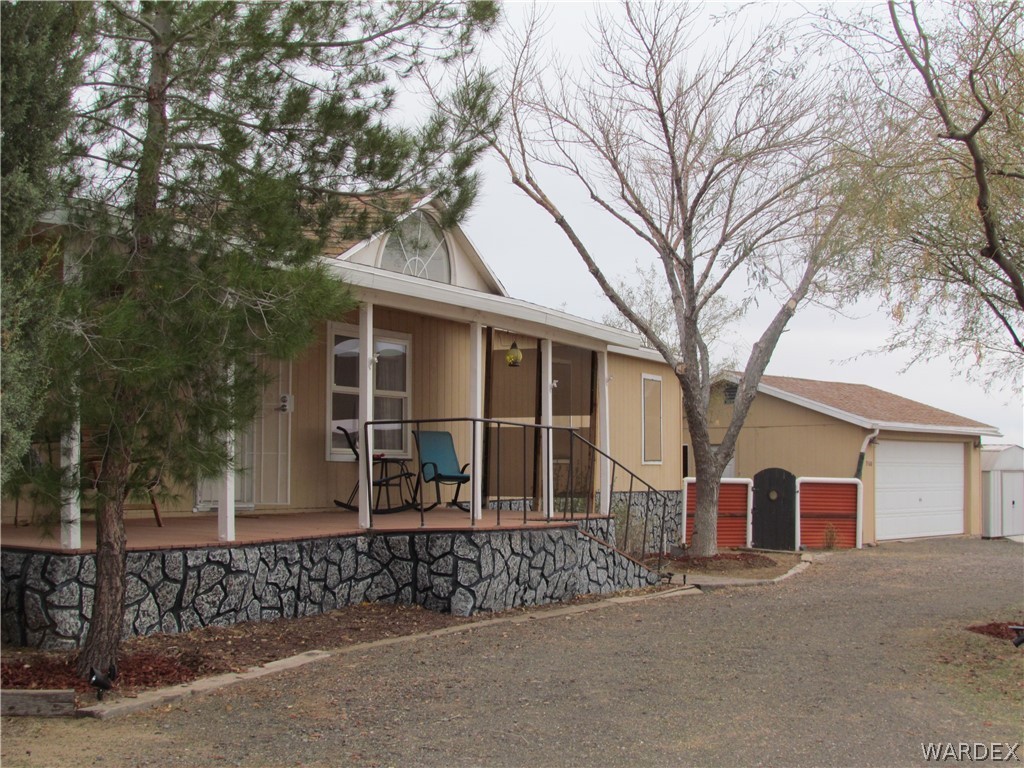 3500 Aztec Road Golden Valley, AZ 86413 - Photo 2 of 23 a front view of a house with a garden