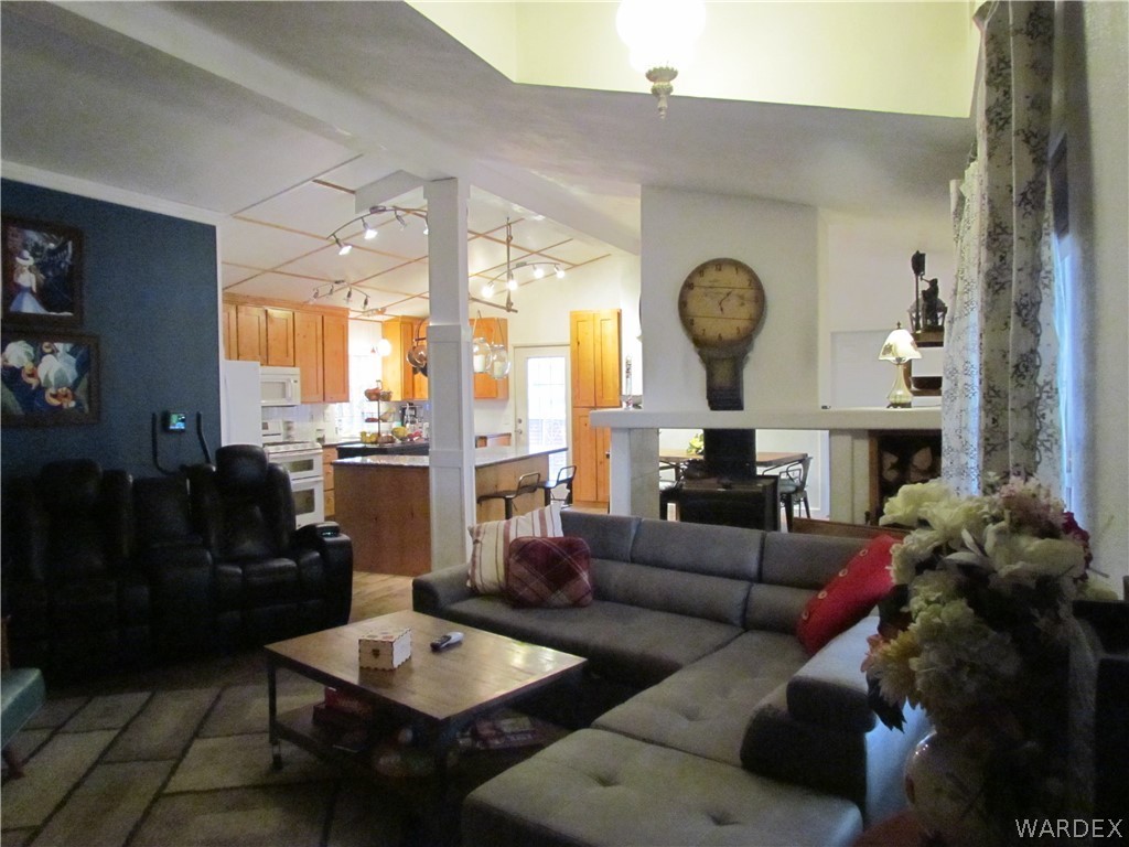 3500 Aztec Road Golden Valley, AZ 86413 - Photo 3 of 23 a living room with furniture a rug and a large window