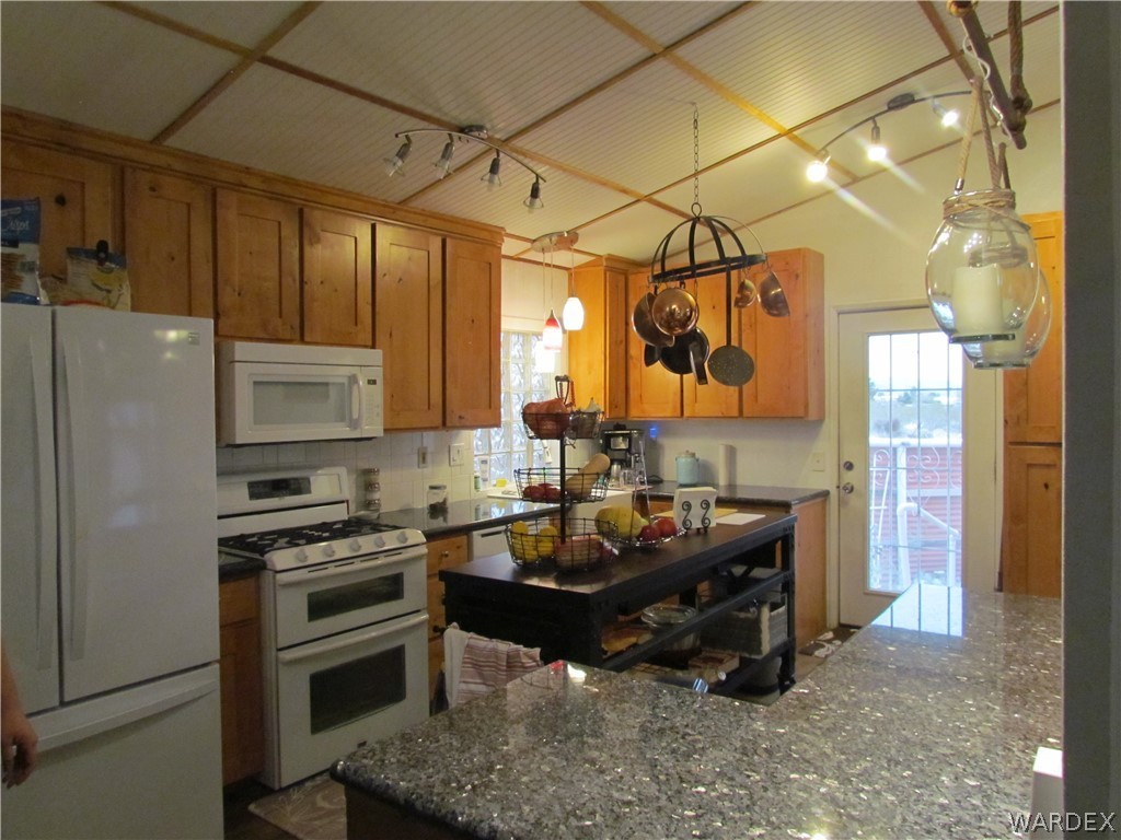 3500 Aztec Road Golden Valley, AZ 86413 - Photo 6 of 23 a kitchen that has a stove and a refrigerator