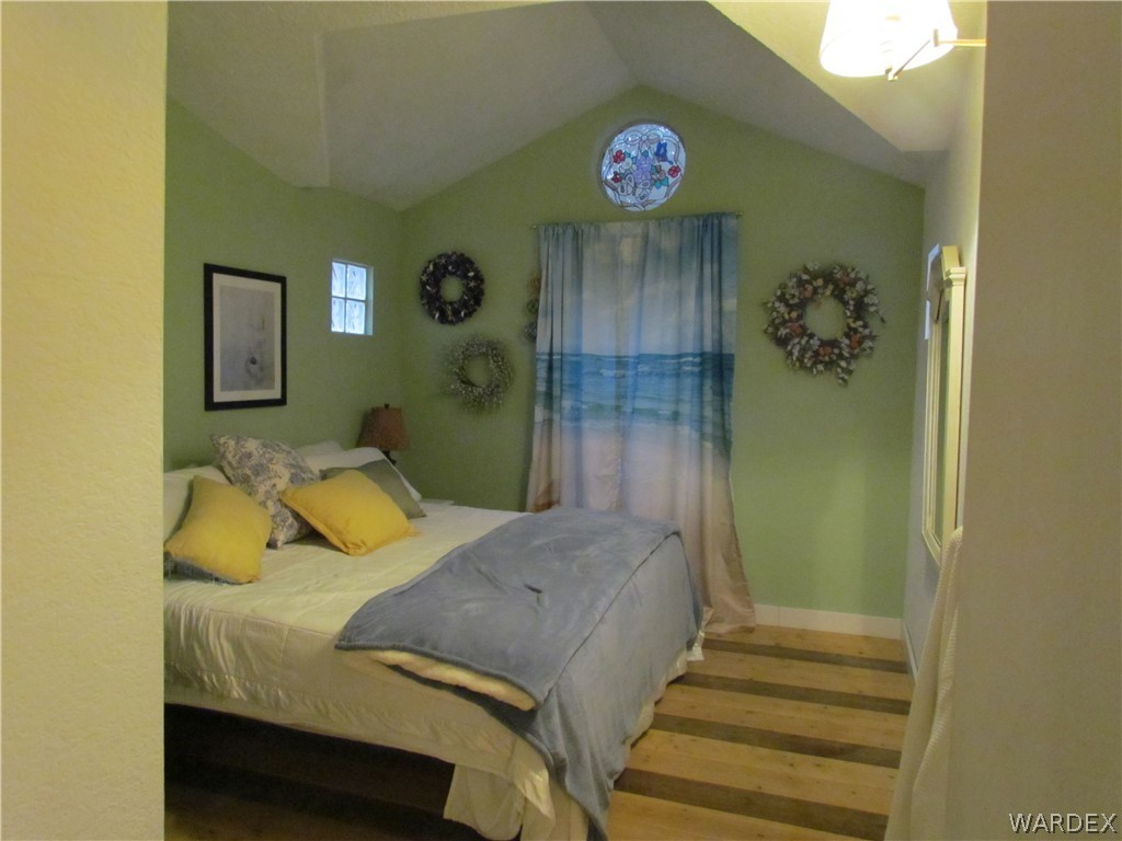 3500 Aztec Road Golden Valley, AZ 86413 - Photo 9 of 23 a bedroom with a bed and a table