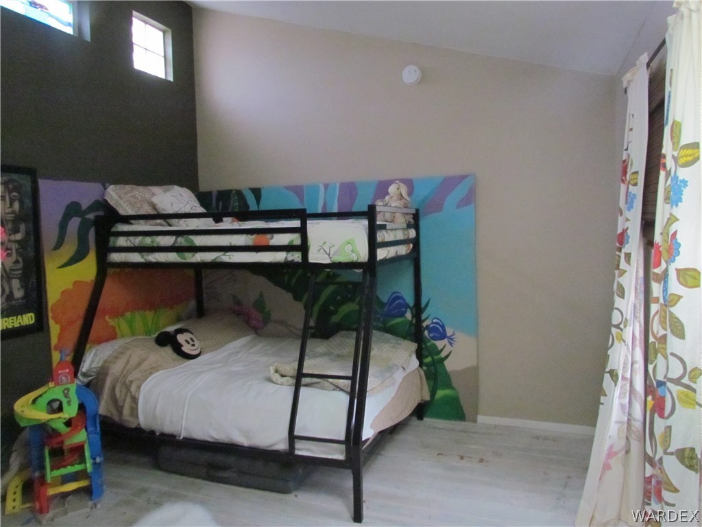 3500 Aztec Road Golden Valley, AZ 86413 - Photo 10 of 23 a bedroom with bunk bed and a couch