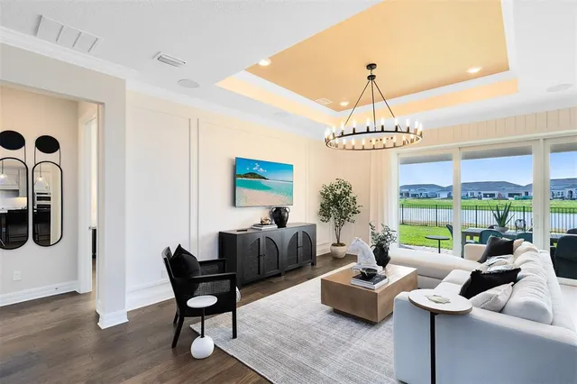 a living room with furniture and a chandelier