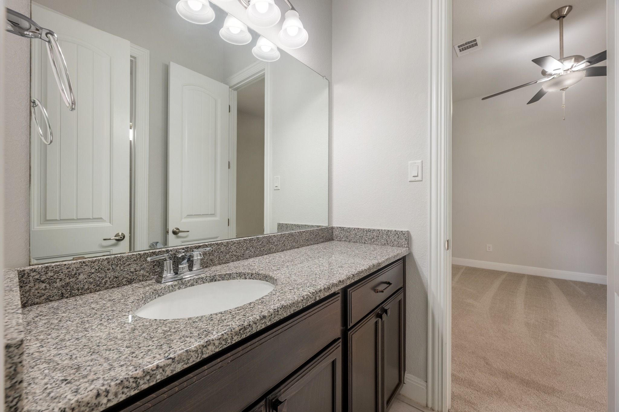 2709 Steece Way Leander, TX 78641 - Photo 35 of 39 a bathroom with a granite countertop sink and a mirror