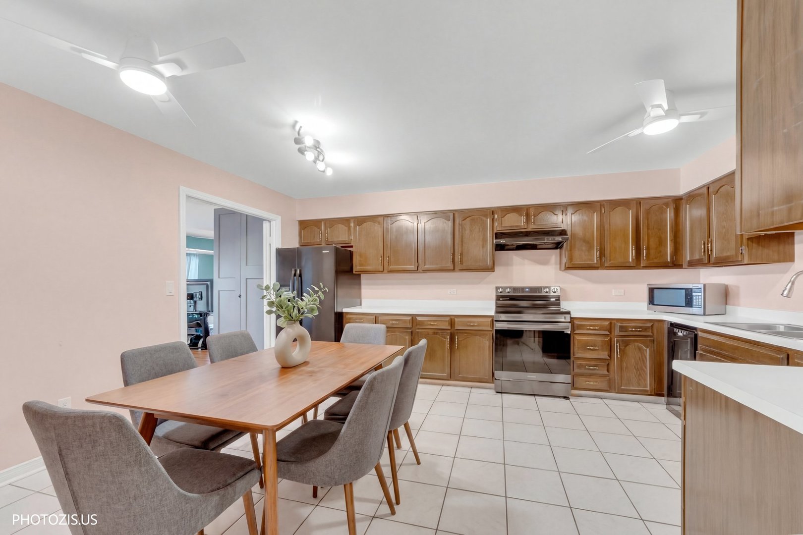 1621 Mission Hills Road, Unit 108 Northbrook, IL 60062 - Photo 7 of 22 a kitchen with stainless steel appliances a dining table chairs stove refrigerator and cabinets