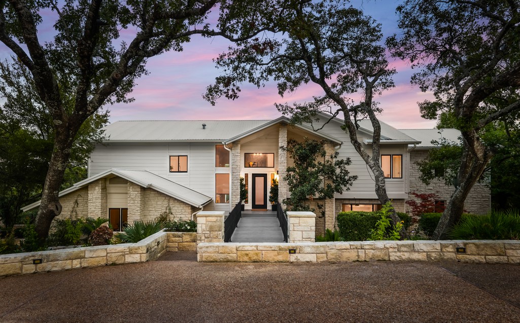 a front view of a house with a tree s