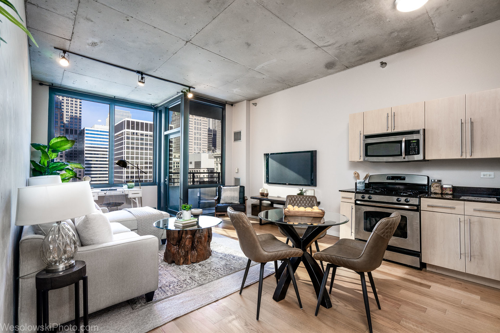 235 West Van Buren Street, Unit 2417 Chicago, IL 60607 - Photo 2 of 22 a living room with furniture a flat screen tv and large windows