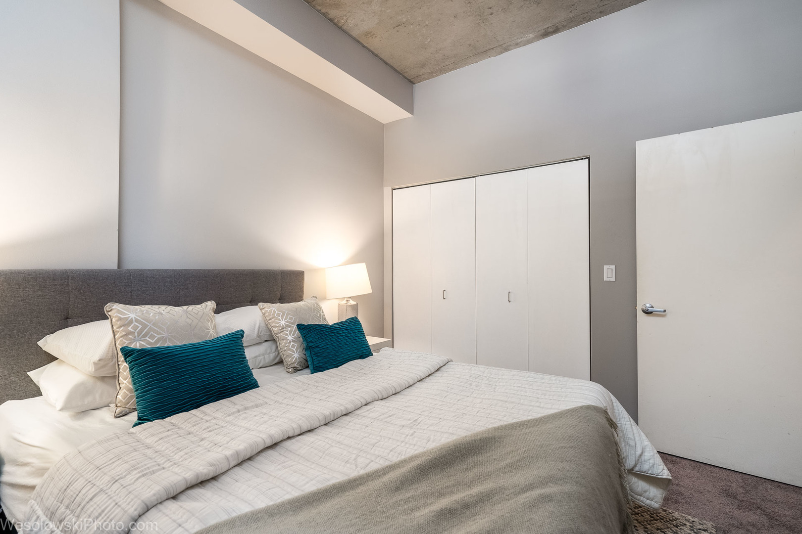 235 West Van Buren Street, Unit 2417 Chicago, IL 60607 - Photo 9 of 22 a bedroom with a bed and a night stand