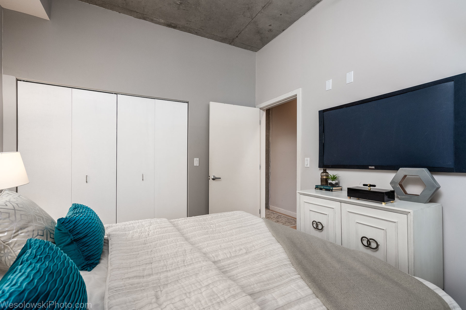 235 West Van Buren Street, Unit 2417 Chicago, IL 60607 - Photo 10 of 22 a bedroom with a bed and flat screen tv