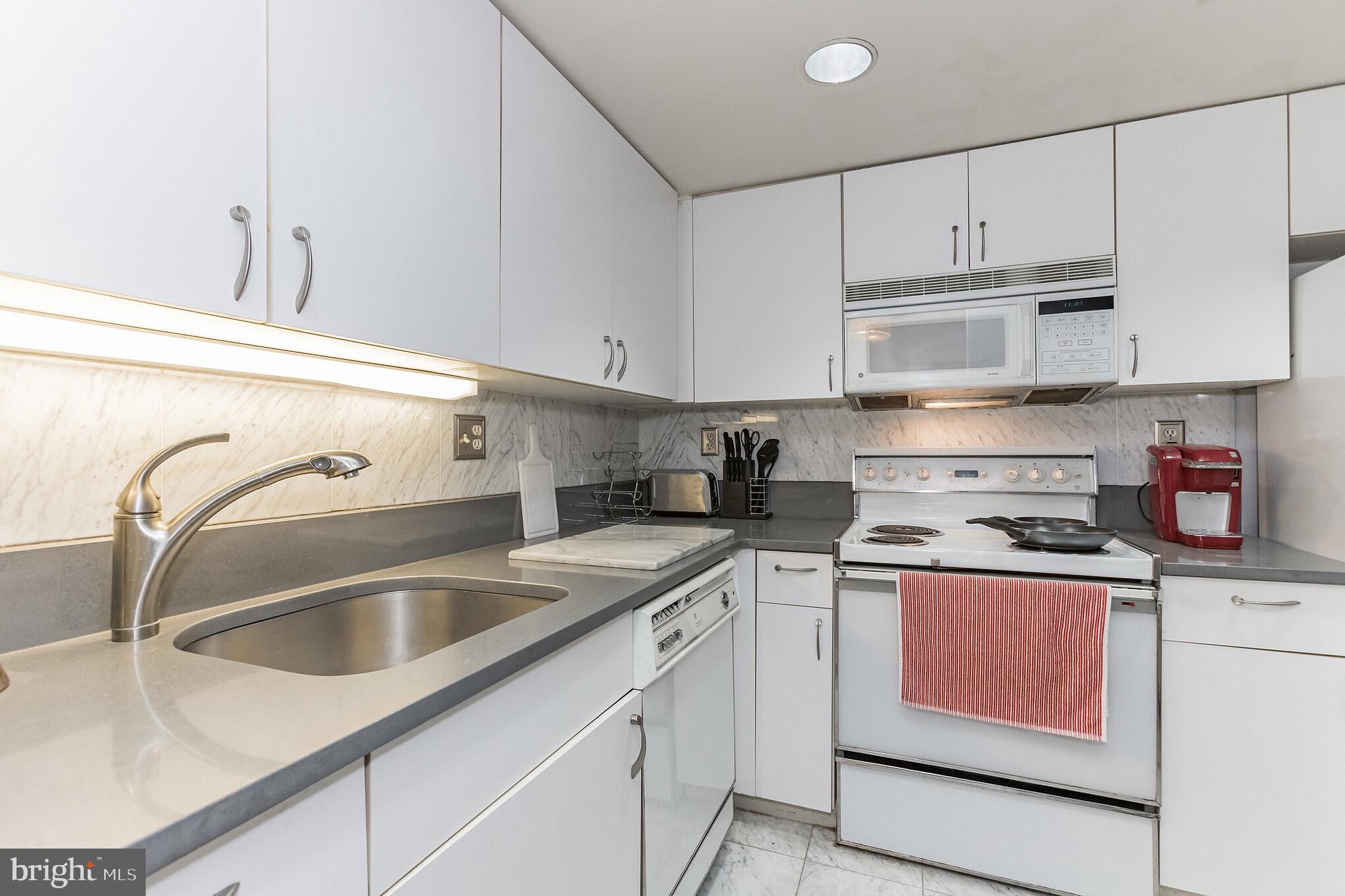 601 Pennsylvania Avenue Northwest, Unit 705 Washington, DC 20004 - Photo 13 of 29 a kitchen with stainless steel appliances granite countertop a sink and cabinets