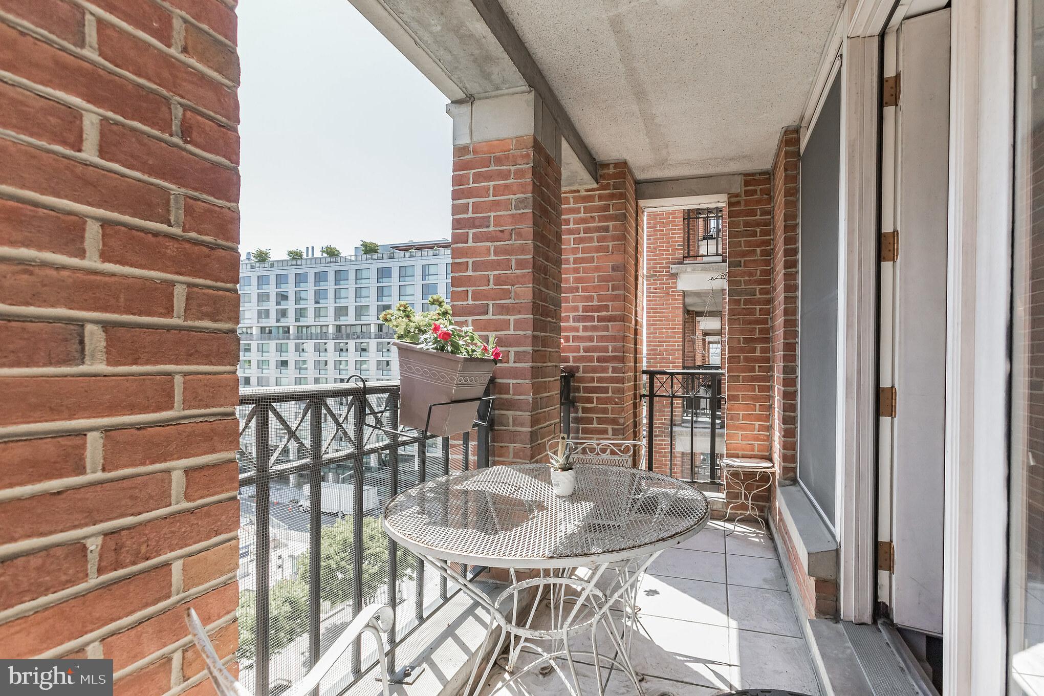 601 Pennsylvania Avenue Northwest, Unit 705 Washington, DC 20004 - Photo 3 of 29 a view of a balcony with table and chairs